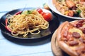 Spaghetti pasta and pizza on wooden tray - Traditional delicious Italian food spaghetti bolognese on plate on the dining table Royalty Free Stock Photo