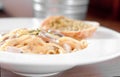 The Spaghetti pasta with sausage and Garlic Bread in white plate Royalty Free Stock Photo