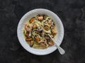 Spaghetti pasta with seafood in wine sauce on a dark background, top view Royalty Free Stock Photo