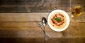 Spaghetti Pasta with Tomato Sauce, Cheese, Basil and White Wine Glass on Wooden Table. Traditional Italian Food. Royalty Free Stock Photo