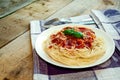 Spaghetti Pasta with Tomato Sauce, Cheese and Basil on Wooden Table. Traditional Italian Food Royalty Free Stock Photo