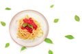 Spaghetti or pasta with tomato sauce and fresh green basil on a white plate isolated on a white background - top view Royalty Free Stock Photo