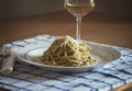 Spaghetti with Pesto Genovese and Pecorino Romano cheese glass of Vernaccia tuscany white wine