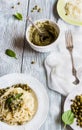 Spaghetti with pesto sauce on white vintage plate, grated cheese, fresh basil leaves and green beans on wooden background Royalty Free Stock Photo