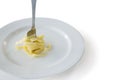 Spaghetti rolled up in fork with plate on white background Royalty Free Stock Photo