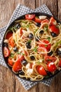 Spaghetti salad with feta, olives, tomatoes and parsley close-up on a plate.Vertical top view Royalty Free Stock Photo