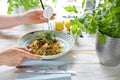 Spaghetti with salmon and sun-dried tomatoes. The woman eats a tasty dish Royalty Free Stock Photo