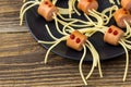 spaghetti with sausages in the form of spiders. Happy kid food for Halloween party Royalty Free Stock Photo