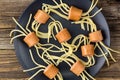 spaghetti with sausages in the form of spiders. Happy kid food for Halloween party. Top view Royalty Free Stock Photo