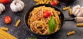 Spaghetti sauteed in a pan-fried with tomatoes and basil