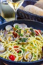 Spaghetti with sea clams, pasta vongole served in cooking pan, tasty italian seafood Royalty Free Stock Photo