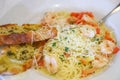 Spaghetti served with shrimp and tomatoes.
