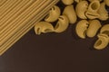 spaghetti and shells on a brown background