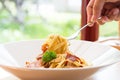 Spaghetti spicy with bacon, parsley and parmesan cheese Fresh pepper, Basil leaf . Pasta Carbonara on white plate. Italian food Royalty Free Stock Photo