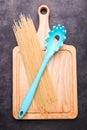 Spaghetti and spoon for spaghetti on a cutting board Royalty Free Stock Photo