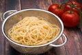 Spaghetti in a stainless steel collander