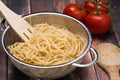 Spaghetti in a stainless steel collander