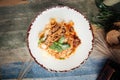 Spaghetti tagliatelle with meat and parmesan cheese garnished with basil leaves