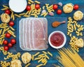 Spaghetti tagliatelle pasta tomatoes cherries ham souses on wooden background Royalty Free Stock Photo