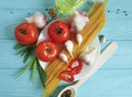 spaghetti, tomato, garlic plate recipe vegetable on a blue wooden background