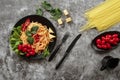 Spaghetti with tomato sauce, cherry tomatoes and basil on a dark background. Tasty appetizing classic italian spaghetti pasta with Royalty Free Stock Photo