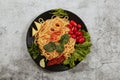 Spaghetti with tomato sauce, cherry tomatoes and basil on a dark background. Tasty appetizing classic italian spaghetti pasta with Royalty Free Stock Photo