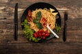 Spaghetti with tomato sauce, cherry tomatoes and basil on a dark background. Tasty appetizing classic italian spaghetti pasta with Royalty Free Stock Photo