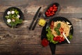 Spaghetti with tomato sauce, cherry tomatoes and basil on a wooden background. Tasty appetizing classic Italian pasta spaghetti wi Royalty Free Stock Photo