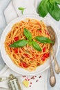 Spaghetti with tomato sauce, fresh Basil, Parmesan cheese, olive oil and spices. Mediterranean Italian cuisine. Delicious pasta Royalty Free Stock Photo