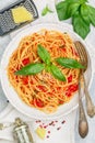 Spaghetti with tomato sauce, fresh Basil, Parmesan cheese, olive oil and spices. Mediterranean Italian cuisine. Delicious pasta Royalty Free Stock Photo