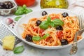 Spaghetti with tomato sauce with garlic, Basil, spices, olives, olive oil and Parmesan cheese in a white plate Royalty Free Stock Photo