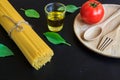 Spaghetti and tomatoes with basil on blackboard