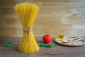 Spaghetti and tomatoes with basil on wooden table