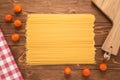 Spaghetti with tomatoes, tablecloth and cutting board Royalty Free Stock Photo