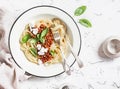 Spaghetti with vegetarian lentil bolognese on a light background.