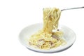 Spaghetti white cream sauce topping slice ham pork rolled in fork on dish Royalty Free Stock Photo