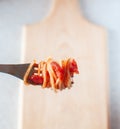 Spaghetti wound on a fork with tomatoes and basil. Royalty Free Stock Photo