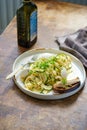 Spaghetti with zucchini and basil pesto on a white plate, rustic style Royalty Free Stock Photo