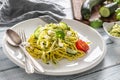 Spaghetti zucchini raw vegan pasta with feta cheese cucumber and basil