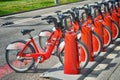 SPAIN, BARCELONA - APRIL 15, 2019:cyclist parking rental bike the same red color on a city street