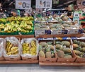 Large fruit section with bananas and pineapples in the foreground for sale