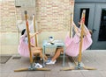 Young couple resting in a cafe while sitting in pink hammocks