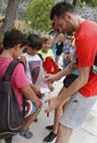 Spain basketball player, and former NBA, Rudy Fernandez signing autographs to a few children on a summer campus