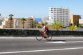 Spain, Canarias, Adeje - December 21, 2019: Cyclists men cycling on a road along ocean.