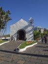 Spain, Canary islands, Tenerife, Puerto de la cruz, December 23, 2017, old small white church and group of walking tourist on pro