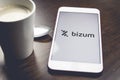 Detail shot of a smartphone with the Bizum application home screen next to a white cup of coffee. Concept of Royalty Free Stock Photo