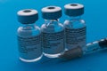 Spain - February 09, 2021 Close up picture of three empty phials of Pfizer COVID19 vaccine with a needle. Selective focus