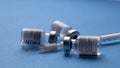 Spain - February 09, 2021 Close up picture of three empty phials of Pfizer COVID19 vaccine with a needle. Selective focus