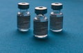 Spain - February 09, 2021 Close up picture of three empty phials of Pfizer COVID19 vaccine with a needle. Selective focus