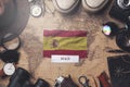 Spain Flag Between Traveler`s Accessories on Old Vintage Map. Overhead Shot Royalty Free Stock Photo